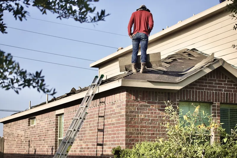 Professional roofer working on a residential roof in McNair Village